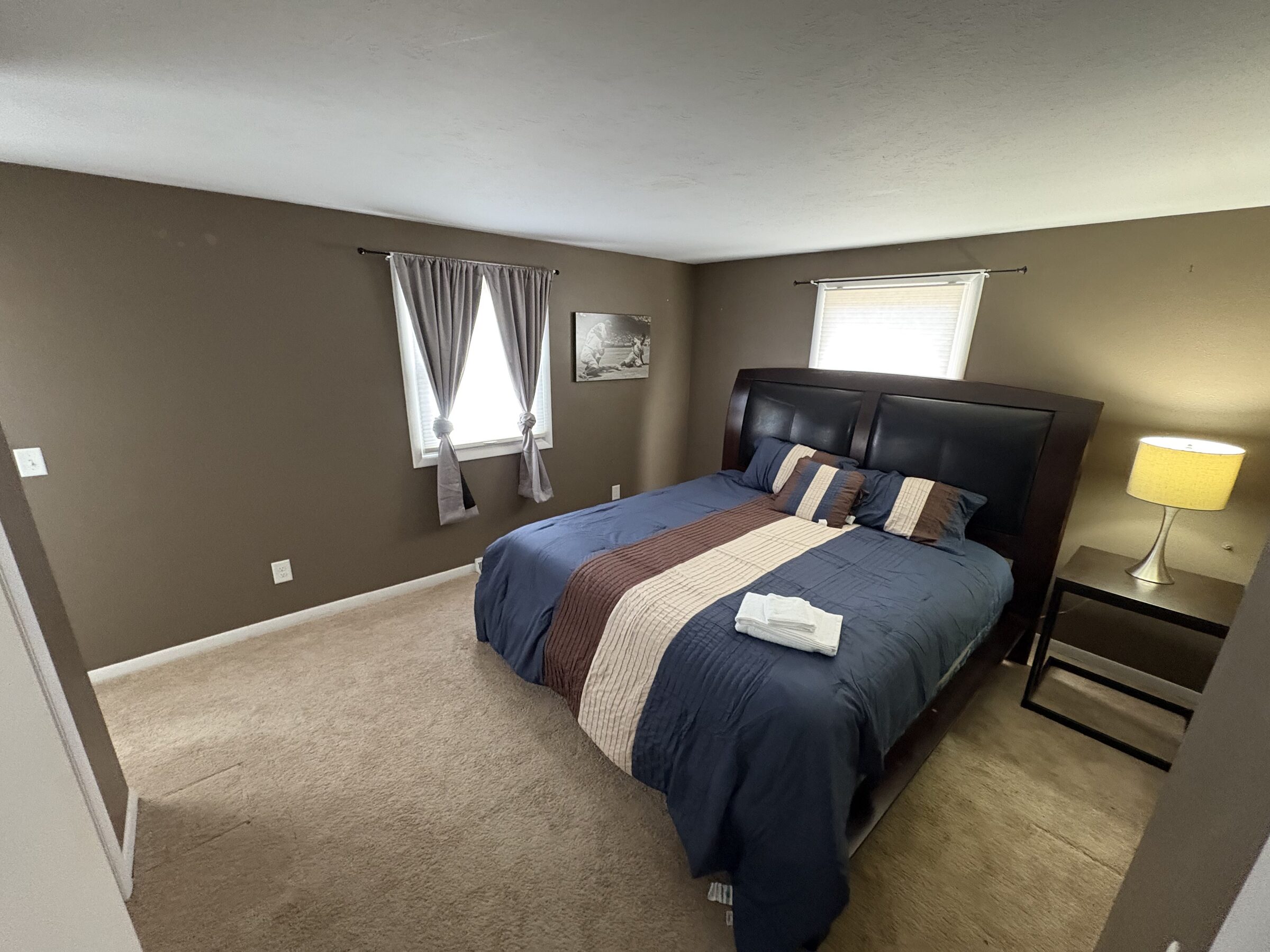 King bedroom with leather headboard and warm accents