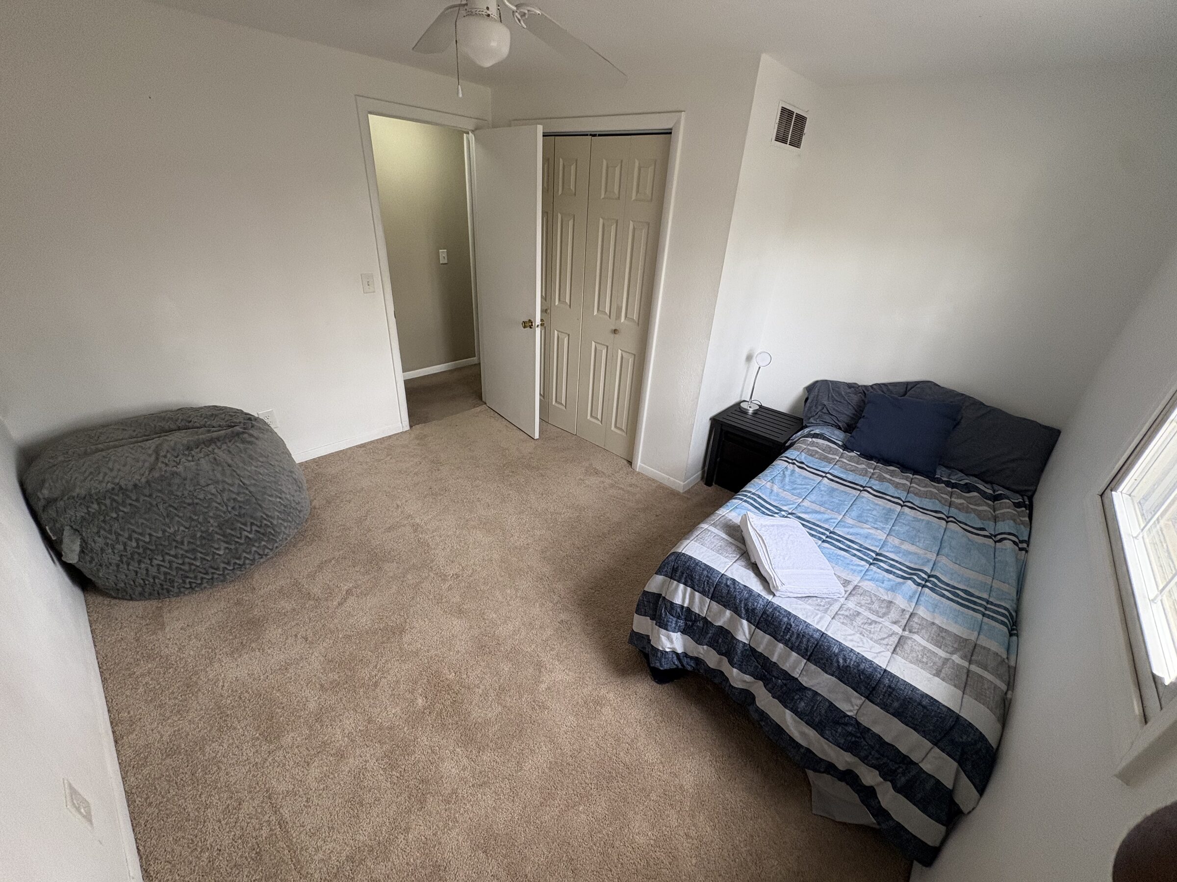 Guest bedroom with queen bed and reading corner