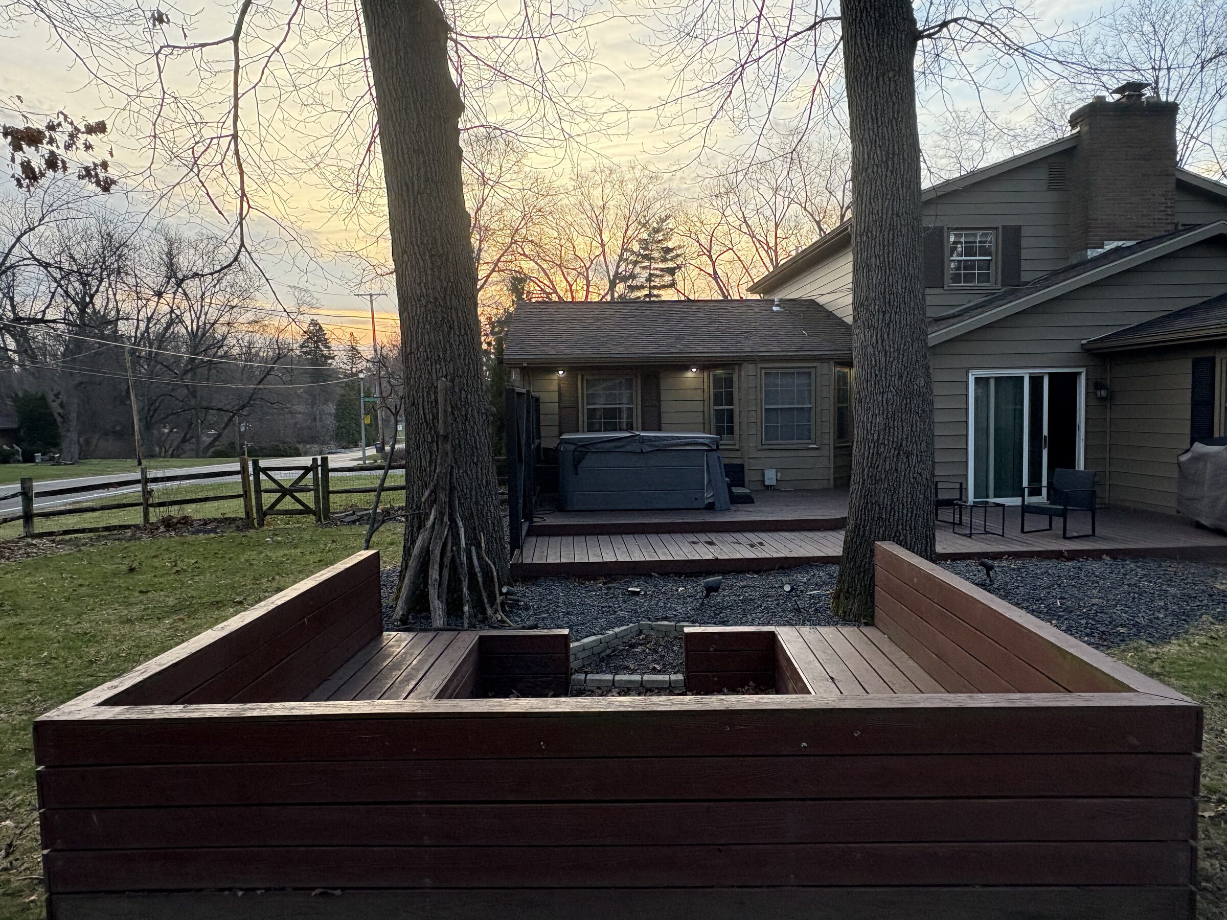 Home exterior with wraparound deck at sunset