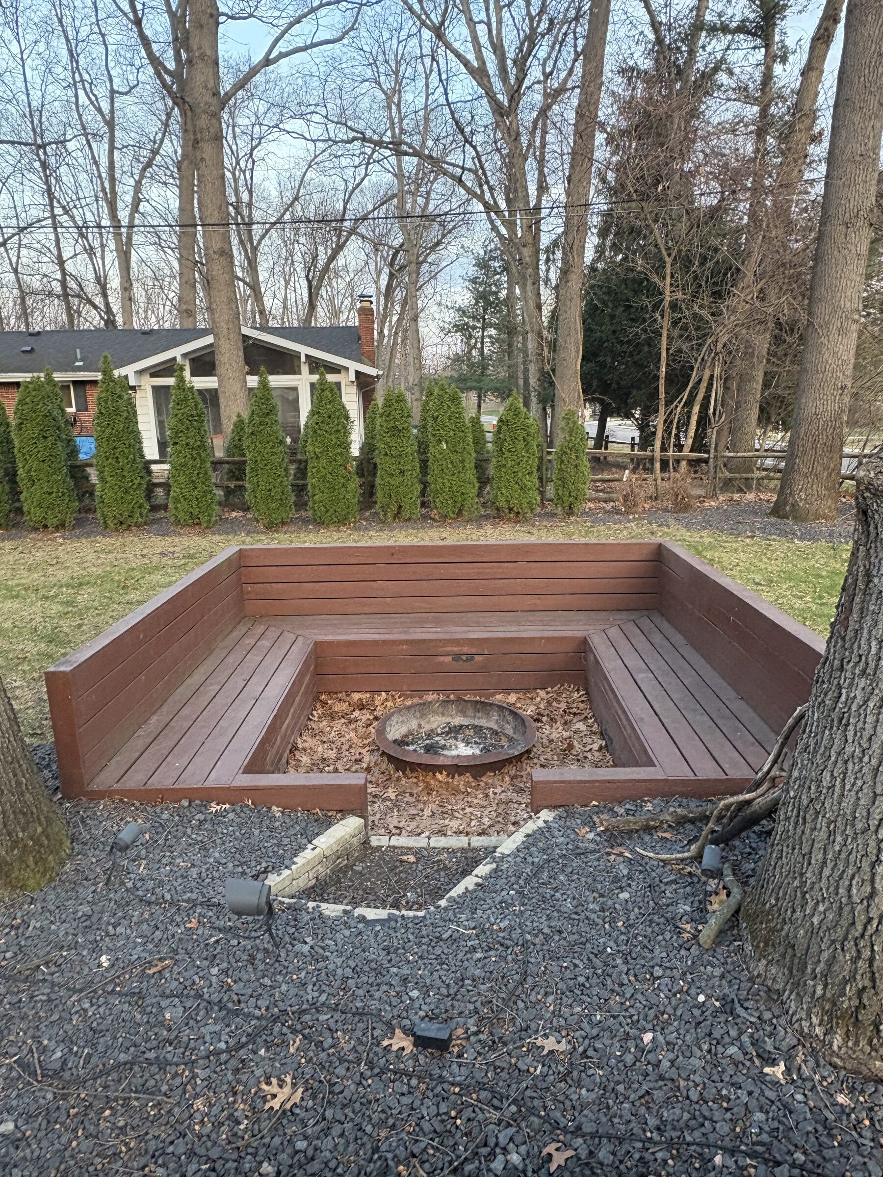 Built-in fire pit with bench seating in the backyard